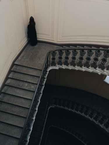 person standing at the corner facing wall